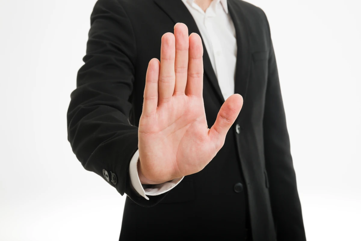 a man holding his hand meaning a stop to stop debt harassment