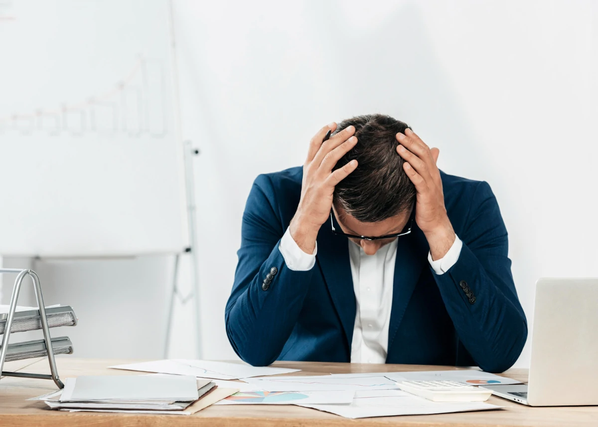 imagine representing a stressed man looking down at some papers